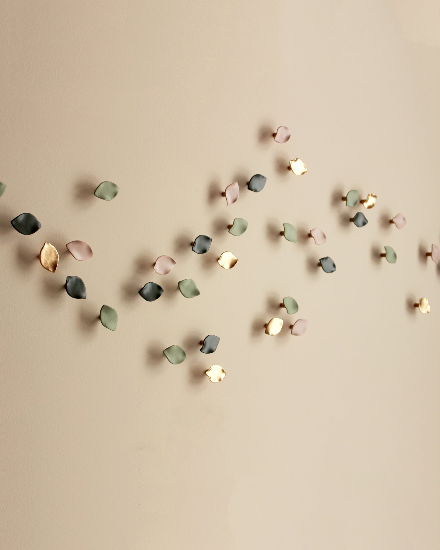 decorative wall sculpture fine art petals made from porcelain in a range ofpink and green tones with gold accents