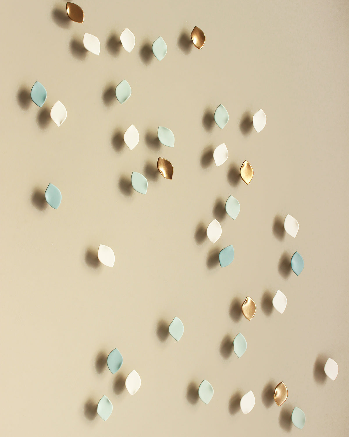 ceramic wall art porcelain wall sculptures in soft blue greens, teal and white with gold accents by elizabeth prince ceramics
